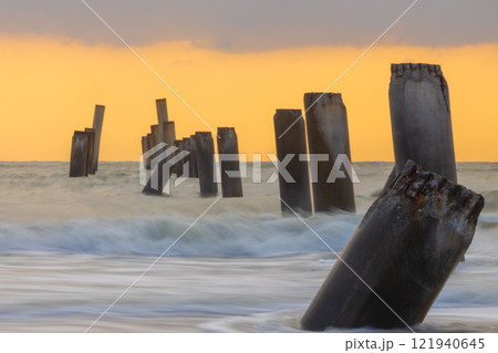 A beautiful sunrise at Sao Eang Beach (old leaning cement pillars) Cha-Am beach, Phetchaburi, Thailand. A beautiful sunrise at Sao Eang Beach (old leaning cement pillars) Cha-Am beach, Phetchaburi, Thailand. 121940645
