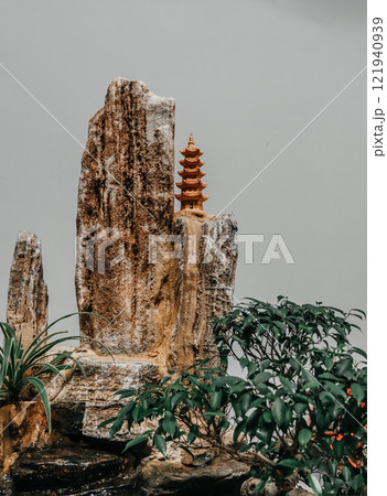 A Serene and Beautiful Natural Landscape Featuring a Pagoda and Stunning Rock Formation 121940939