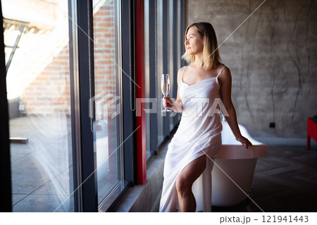 Woman relax with glass of vine in bathrobe at home, closeup 121941443