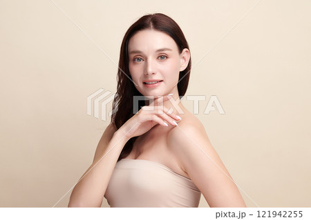 Beautiful young woman with clean fresh skin on beige background, Face care, Facial treatment, Cosmetology, beauty and spa, women portrait. 121942255