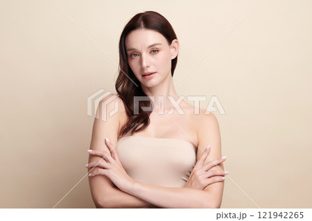 Beautiful young woman with clean fresh skin on beige background, Face care, Facial treatment, Cosmetology, beauty and spa, women portrait. 121942265