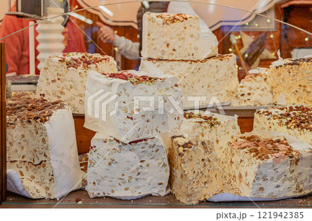 Large nougat pieces with nuts on display at market. Concept of sweet treats 121942385