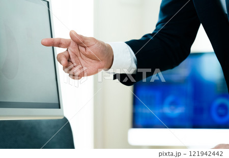 パソコンの前で説明するビジネスマン 121942442