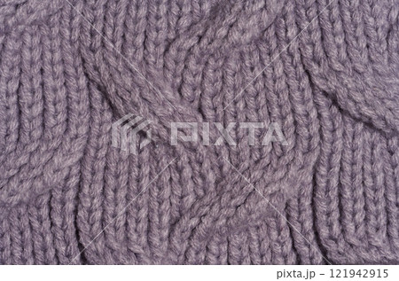 Knitted fabric made of purple wool threads, pigtail pattern, full frame 121942915