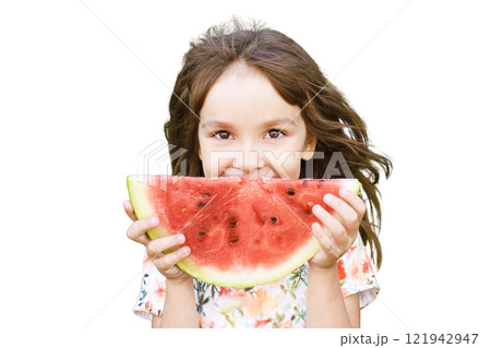 Young caucasian girl enjoying a summer snack with a large watermelon slice Young caucasian girl enjoying a summer snack with a large watermelon slice 121942947