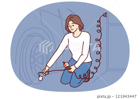 Woman is repairing car wheel using pump to pump air into tires and go on road trip 121943447