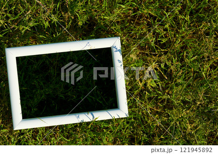 White frame with black space for text on freshly greenery grass White frame with black space for text on freshly greenery grass 121945892