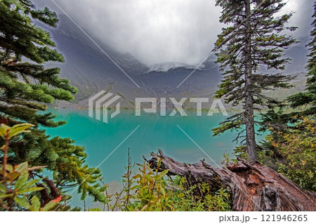Hiking view near Mt Garibaldi with turquoise lake and dramatic clouds in the mountains Hiking view near Mt Garibaldi with turquoise lake and dramatic clouds in the mountains 121946265