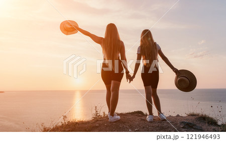 Silhouettes of Two Women at Sunset Silhouettes of Two Women at Sunset 121946493