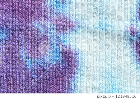 Close up of multicolored knitted fabric texture with purple and blue patterns 121948316