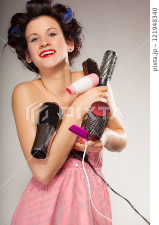 funny girl styling hair holds many accessories 121948340