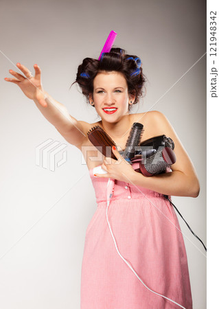 funny girl styling hair holds many accessories 121948342