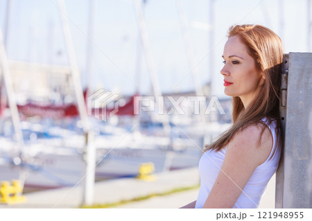 Sad woman walking outdoor 121948955