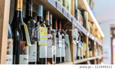 Bottles of wine on a shelf in a store Bottles of wine on a shelf in a store 121949311