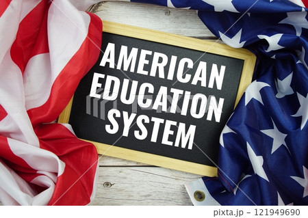 American Education System text messege with USA flag on wooden background American Education System text messege with USA flag on wooden background 121949690