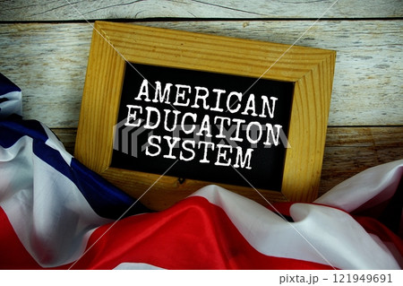 American Education System text messege with USA flag on wooden background American Education System text messege with USA flag on wooden background 121949691