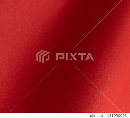 Red paper background with fiery tones and a soft matte gradient. Warm and vibrant hues blend 121950088