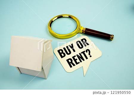 Buy Or Rent? text message on sticky note with magnifying glass and house model on blue background 121950550
