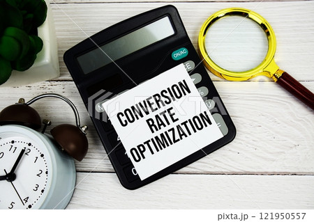 Conversion Rate Optimization text message on sticky note with magnifying glass, alarm clock and calculator on wooden background Conversion Rate Optimization text message on sticky note with magnifying glass, alarm clock and calculator on wooden background 121950557