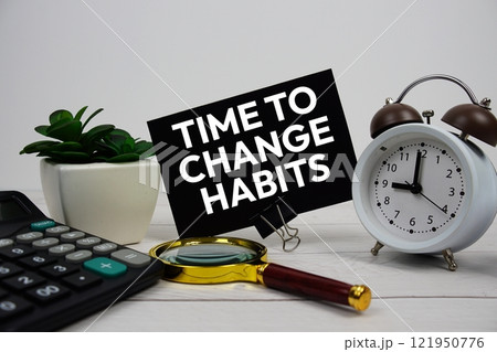 Time to Change Habits text message with calculate, alarm clock and magnifying glass on wooden background 121950776