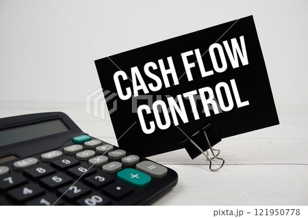 Cash Flow Control text message on sticky note with calculator on wooden background 121950778