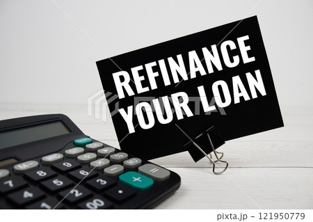 Refinance Your Loan text message with calculate on wooden background 121950779