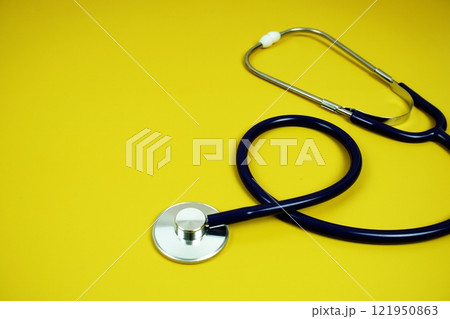 Stethoscope medical equipment isolated on yellow background Stethoscope medical equipment isolated on yellow background 121950863