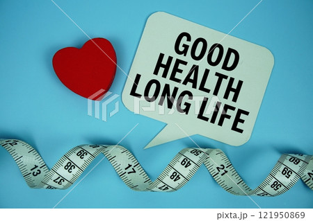 Good Health Long Life text on speech buble with red heart and measuring tape on blue background Good Health Long Life text on speech buble with red heart and measuring tape on blue background 121950869