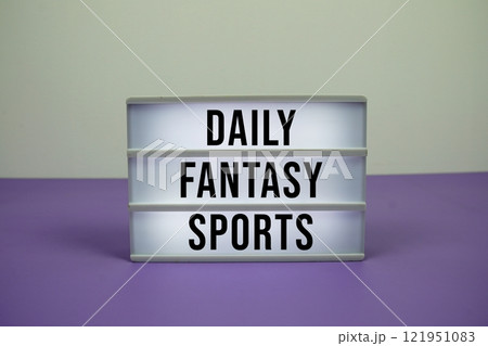Daily Fantasy Sports text on LED lightbox on purple background 121951083