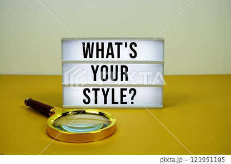What's Your Style? text on LED lightbox with magnifying glass on yellow background 121951105