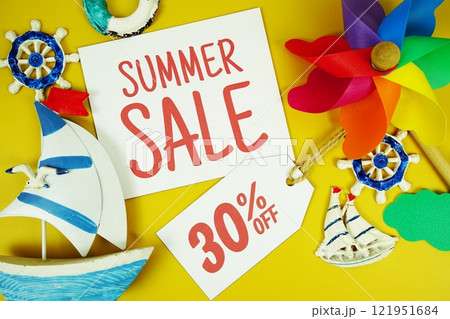 SUMMER SALE 30% OFF text on paper card with marine items decorative top view on yellow background 121951684