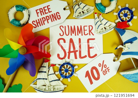 SUMMER SALE 10% OFF text on paper card with marine items decorative top view on yellow background 121951694