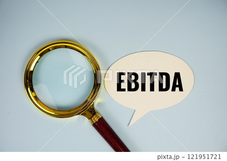 EBITDA text on speech bubble with magnifying glass top EBITDA text on speech bubble with magnifying glass top 121951721