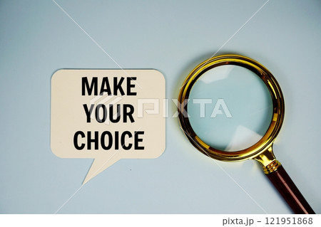 Make your choice text on speech bluble with magnifying glass top view on blue background 121951868