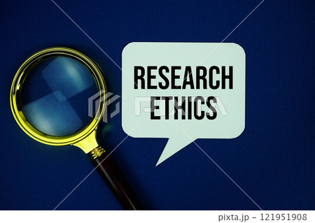 Research Ethics text on speech bubble with magnifying glass top view on blue background 121951908