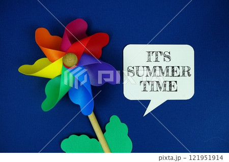 It's Summer Time text motivational and inspiration quote with colorful pinwheel top view on blue background It's Summer Time text motivational and inspiration quote with colorful pinwheel top view on blue background 121951914