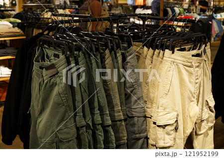 Cargo shorts display in a colorful retail setting at a busy store 121952199