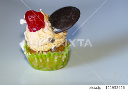 Sweet cake with cream and cherry and chocolate cookie 121952426