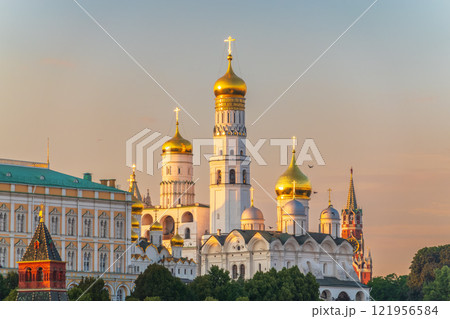 Ivan the Great Bell Tower, with Assumption Belfry on the right in Moscow Kremlin. Blue sky background with sunbeams 121956584