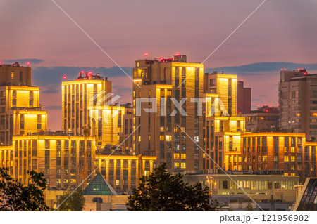 Night colorful windows lights of the high-rise residential building in city sleeping area Night colorful windows lights of the high-rise residential building in city sleeping area 121956902