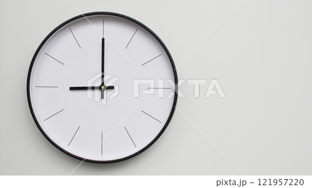 Wall Clock Showing 21.00/09.00 O'Clock on White Wooden Surface - Perfect for Time Management and Scheduling Concepts 121957220