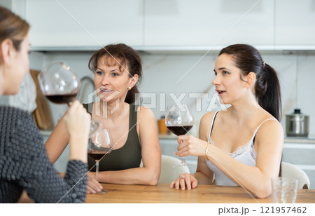 Three women have nice chat-in with wine and conversation 121957462