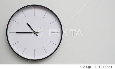 Wall Clock Showing 22.45/10.45 O'Clock on White Wooden Surface - Perfect for Time Management and Scheduling Concepts Wall Clock Showing 22.45/10.45 O'Clock on White Wooden Surface - Perfect for Time Management and Scheduling Concepts 121957784