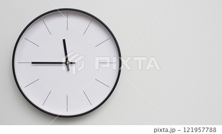 Wall Clock Showing 23.45/11.45O'Clock on White Wooden Surface - Perfect for Time Management and Scheduling Concepts 121957788
