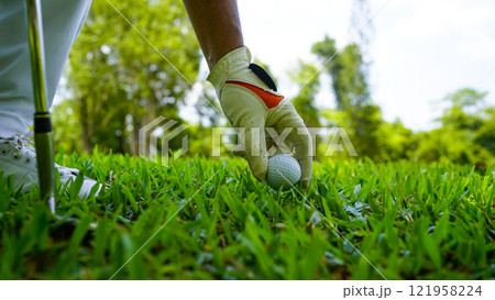 golfer playing golf in the evening golf course, on sun set evening time. 121958224