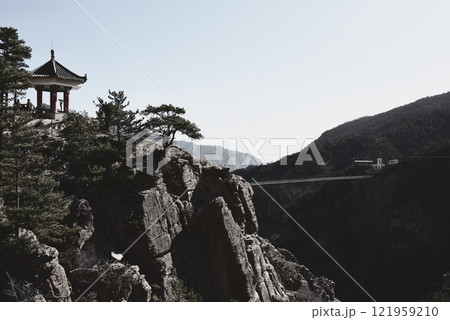 吊り橋と岩山のある風景 121959210