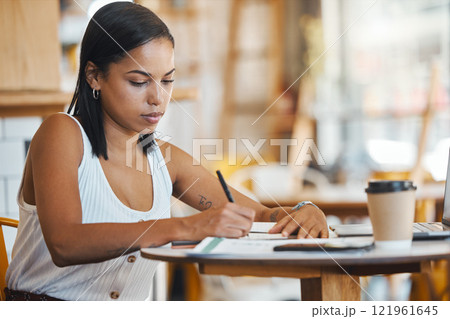 Small business owner, startup entrepreneur or cafe store manager writing notes, working on strategy or planning in a coffee shop. Professional, finance and budget businesswoman filling out papers. 121961645