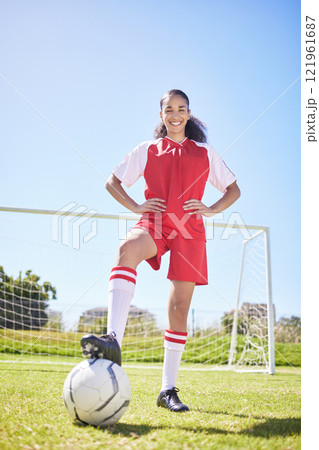 Sports, football and female athlete training at stadium grass sport field with goal post. Portrait of smiling, excited and happy woman soccer player getting ready for workout standing on green pitch Sports, football and female athlete training at stadium grass sport field with goal post. Portrait of smiling, excited and happy woman soccer player getting ready for workout standing on green pitch 121961687