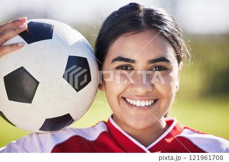 Training, football and portrait of a sporty woman face and soccer ball, enjoying sport and a healthy lifestyle at a field or park. Happy player having fun with fitness, being active and carefree 121961708