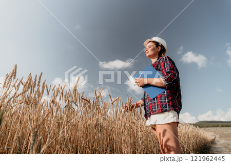 A Woman in a Wheat Field Holding a Clipboard A Woman in a Wheat Field Holding a Clipboard 121962445